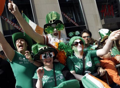 People watch the St Patrick's Day Parade on 5th Avenue in New York City